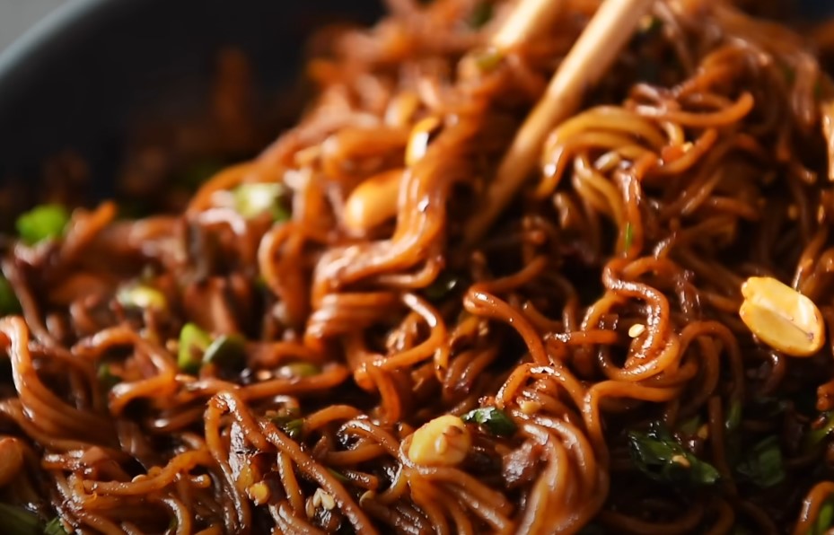 A close-up view of a flavorful, dark-brown stir-fry noodle dish